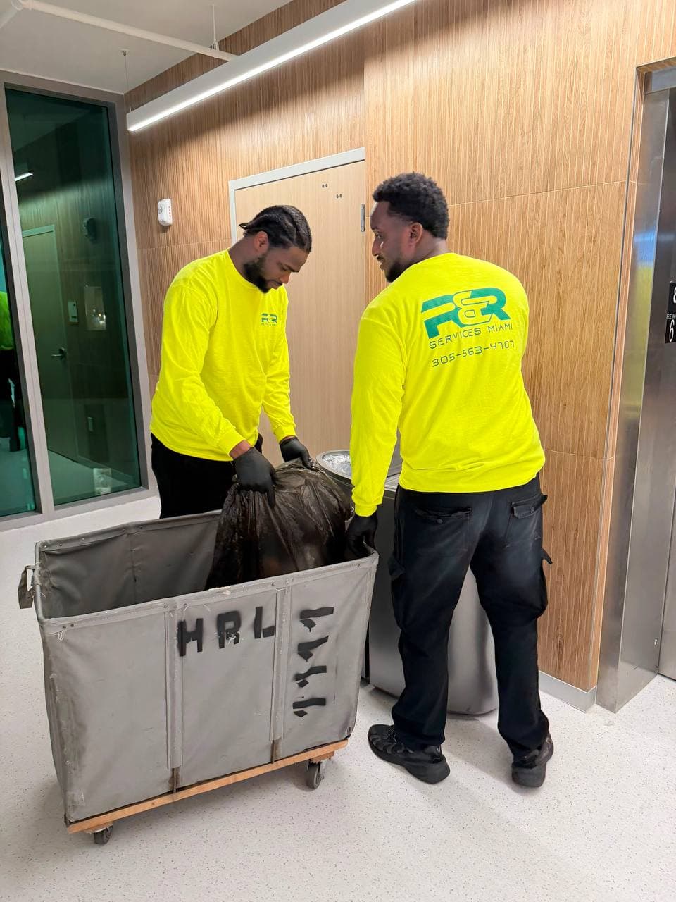 Uniformed R&R cleaning crew servicing an open commercial floor